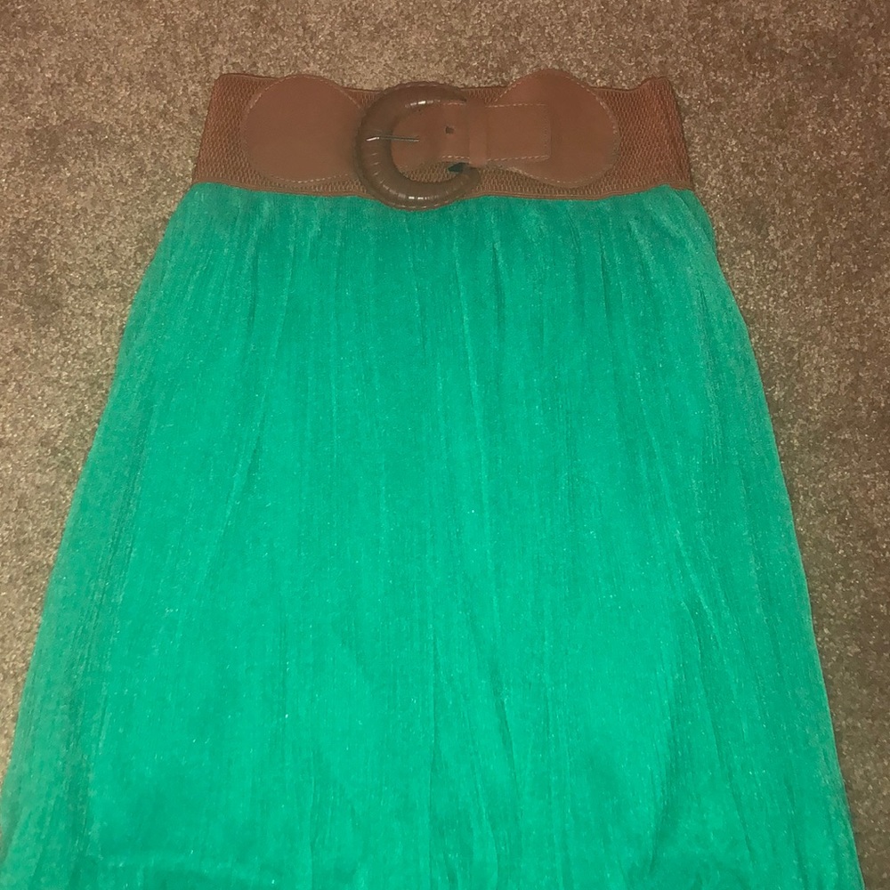 Green high low skirt with a brown belt